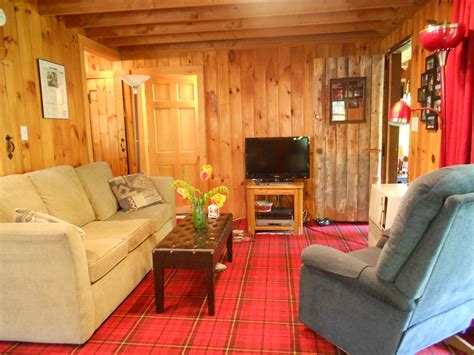 Living room with slider to farmers porch. Log cabin for sale in Norway