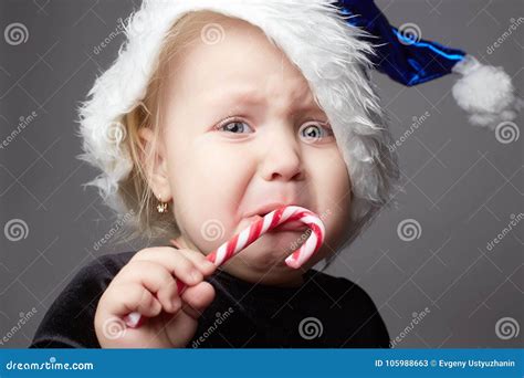 Crying Baby Kid With Candy Sad Child In Christmas Time Stock Image