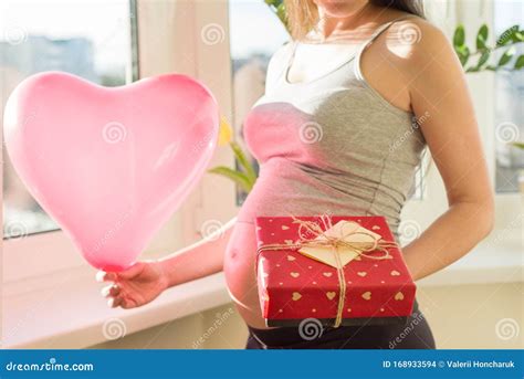 Pregnant Female With Valentines T Box And Red Heart Balloon Stock