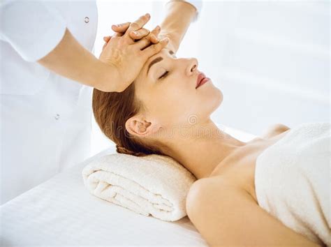 Beautiful Woman Enjoying Facial Massage With Closed Eyes In Spa Center Stock Image Image Of
