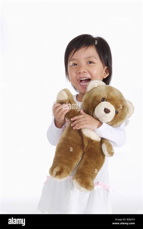 Little Girl Holding Teddy Bear And Smiling Happilychild Stock Photo