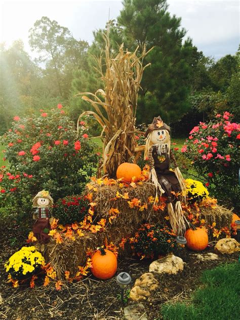 Fall Display At Driveway Entrance With Mums Pumpkins Corn Stalks Hay