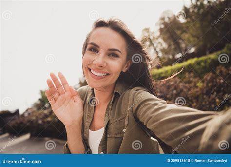 Photo Of Positive Lovely Young Girl Shooting Selfie Waving Palm Wear