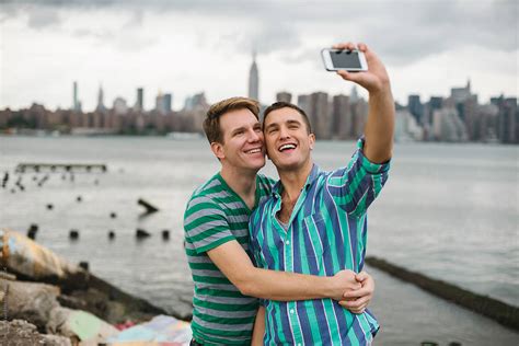 Gay Couple Taking A Selfie Against Manhattan Skyline By Stocksy Contributor Simone Wave
