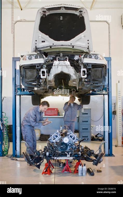 Mechanics Working On Car In Garage Stock Photo Alamy