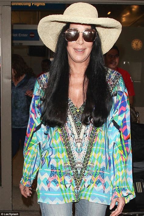 Cher In Bell Bottoms And Multi Coloured Shirt As She Jets Into Los
