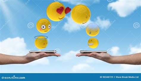 Digitally Generated Image Of Emojis Flying Over Hands Holding Smart