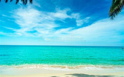 Golden Sand Beach By The Sea With Emerald Green Sea Water And Blue Sky