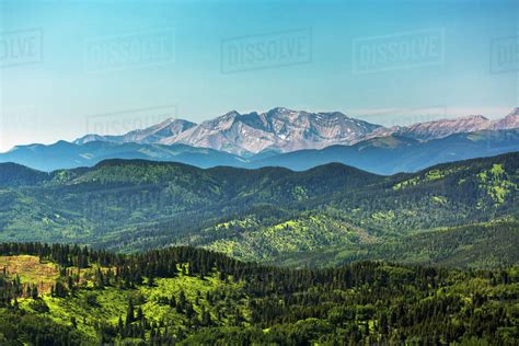 Viewpoint Of Rolling Foothills With Mountain Range In Background And