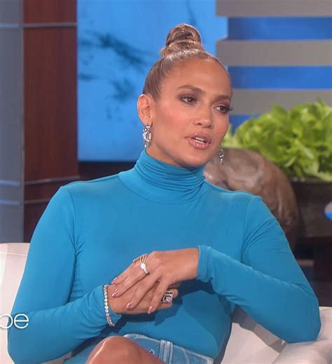 jennifer lopez wearing all blue outfit on ellen degeneres show and top knot bun hair style with