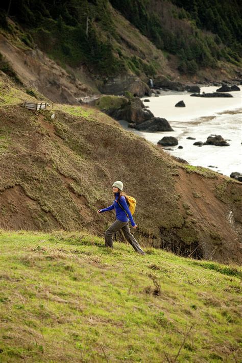 A Woman Hiking Along A Trail Leading Photograph By Jordan Siemens