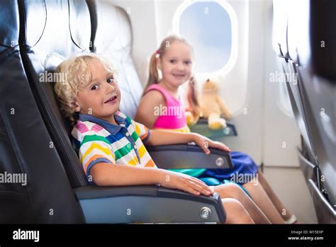 Child In Airplane Kids Sit In Air Plane Window Seat Flight