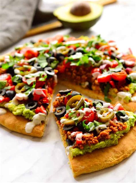 An easy way to take care of a pizza or nacho craving without blowing your diet! Vegan Nacho Pizza | The Stingy Vegan