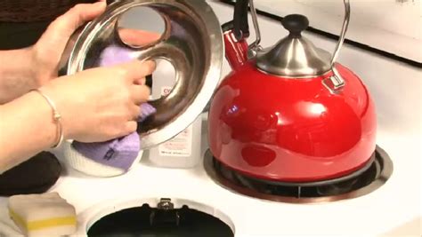Now, use a scrub brush to remove the stains and take care of the grease that may be baked down. Video: How to Clean a Stove With Stuck Grease | eHow