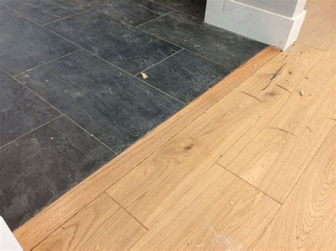 The experts at the diynetwork.com show how to fix tile flooring between wooden and tile floors and install a stylish transition between the two using any diyer with moderate skills can install a wood molding transition between tile and hardwood floors, giving a stylish finish between the two materials. $100 to install this transition piece between the slate ...