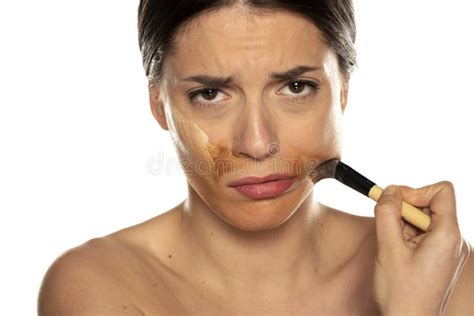 Young Nervous Woman Smearing Three Different Tones Of Liquid Foundation