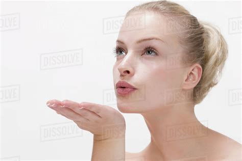 Beauty Portrait Of Woman Blowing Kiss Stock Photo Dissolve