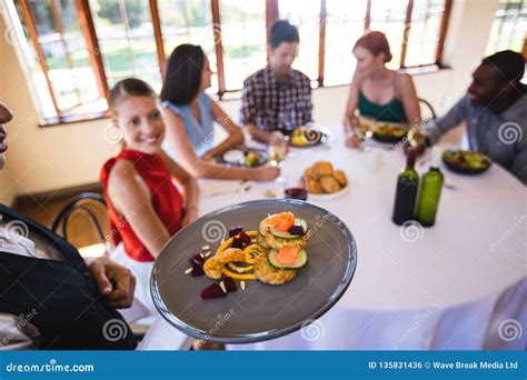 Waitress Holding Food On Plate In Restaurant Stock Photo Image Of