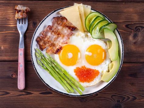 Top View Of Ketogenic Diet Breakfast On The White Plate With A Fork On