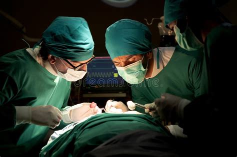 Team Doctors In Operating Room Dressed Green Uniforms Saving Lives