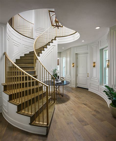 There Is A Spiral Staircase In The Middle Of This Room With Wood Floors
