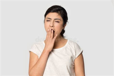 Sleepy Tired Indian Girl Yawning Covering Mouth With Hand Stock Photo