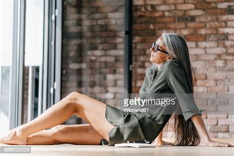 Woman Sitting On The Floor With Bare Feet Photo Getty Images