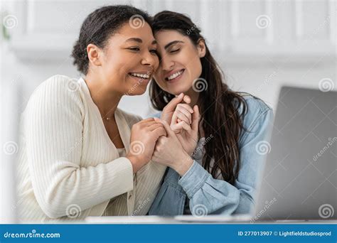 pleased interracial lesbian couple holding hands stock image image of attractive kitchen