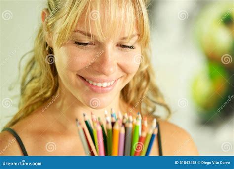 Young Female Artist Holding Colored Pencils And Smiling Stock Image