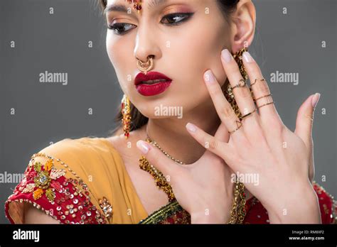 Elegant Indian Woman In Sari And Accessories Isolated On Grey Stock