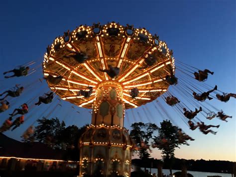 Illuminated Swing Ride At Dusk At An Amusement Park Stock Image Image