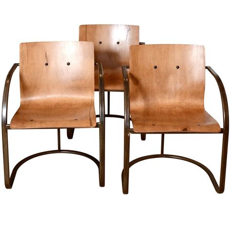 The arms are closed and often in a classic rolled shape. 1960's French Ashwood Chairs with Steel Base / 1stdibs ...