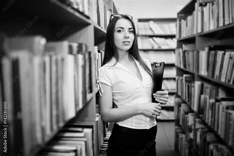 brunette girl at library with folder of documents wear on white blouse and black mini skirt