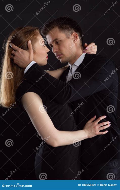 Couple Passionately Hugging In Front Of A Kiss A Man And A Woman Look