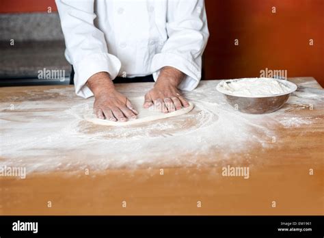 Baker kneading a dough Stock Photo - Alamy