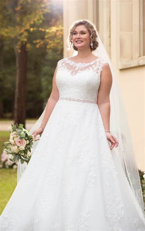 a woman in a wedding dress standing outside