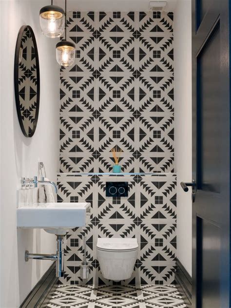 The baby blue zellige tiles and sleek matte black and glass enclosure run tile from the bathroom floor straight into the shower stall, like alla akimova did here. Small Bathroom Ideas - Bob Vila