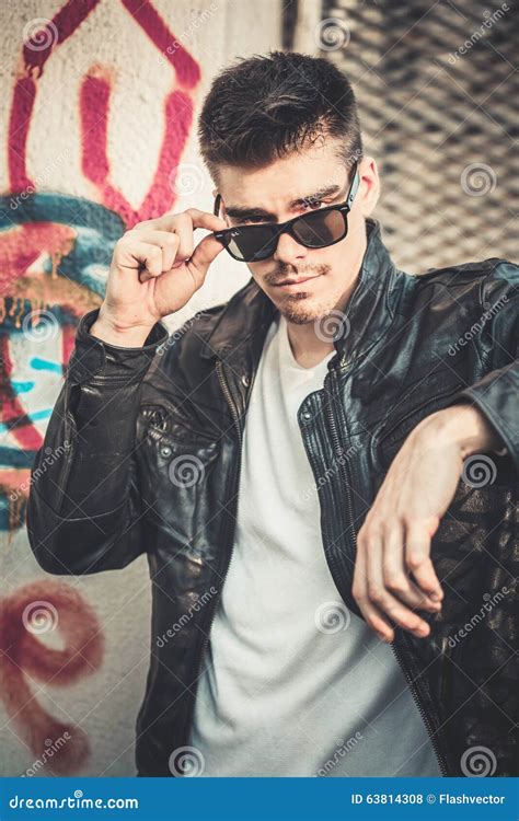 Young Stylish Man Model Posing In Leather Jacket And Sunglasses Stock