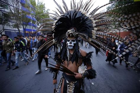 A Protester Dressed In An Aztec Costume Walks During A Massive March In Mexico City Photo