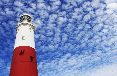 Beacon White And Red Lighthouse Under Cloudy Sky Blue Image Free Photo