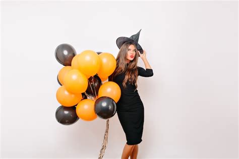Free Photo Shapely Female Model In Witch Hat Smiling Before Halloween