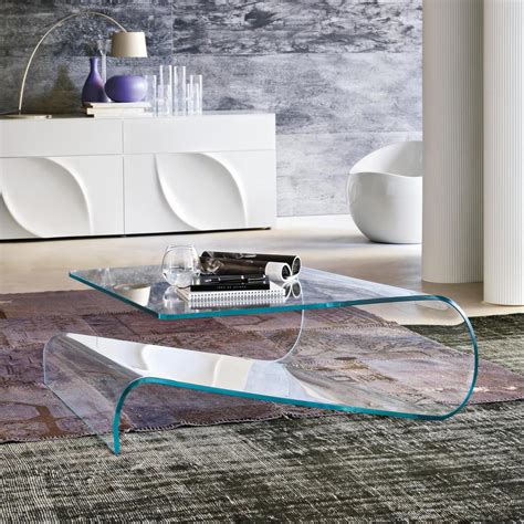 With a c shaped bent glass frame and a tempered glass shelf, the waterfall bent glass coffee table with storage shelf is once an art piece and a highly functional coffee table. Velo Curved Glass Coffee Table - Klarity - Glass Furniture