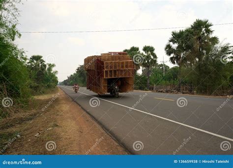 A Motorcycle Runs On National Highway 6 In Cambodia Loading Lots Of