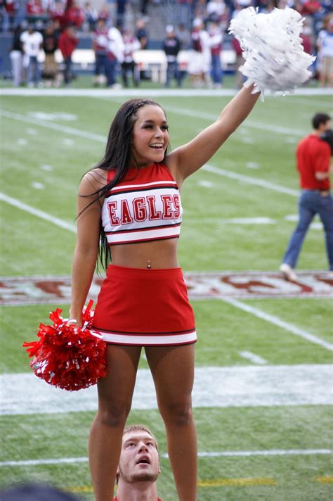 A Cheerleader On The Sidelines At A Football Game