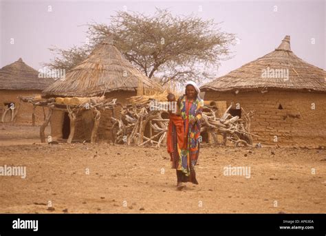 Fulani Woman Outside Mud Hut In Village In Burkina Faso In West Africa