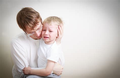 Father Comforting Her Crying Little Son Stock Photo Download Image