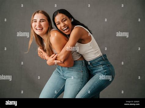 Two Female Friends Smiling And Laughing Playing Around And Having Fun Stock Photo Alamy