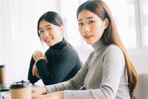 Two Asian Business Women Are Gathered In The Office Stock Photo Image