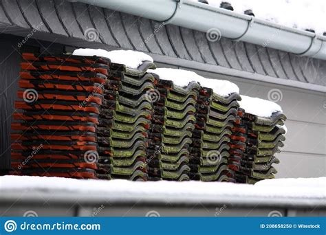 Closeup Of Used Snow Covered Roof Tiles Stacked On A Carport Stock