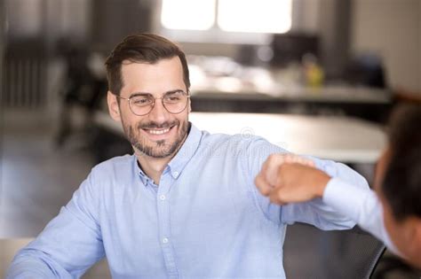 Smiling Man Fist Bumping With Colleague At Workplace Stock Image Image Of Bump Glad 154156407
